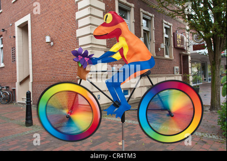Weatherman "frog" on a bike, wind chimes, Papenburg, Lower Saxony, Germany, Europe Stock Photo
