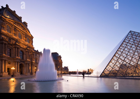 France, Paris, Louvre Museum and Pyramid by the architect Ieoh Ming Pei in the Cour Napoleon, lighting by Claude Engle Stock Photo