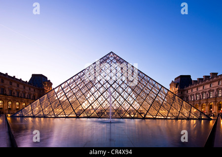 France, Paris, Louvre Museum and Pyramid by the architect Ieoh Ming Pei in the Cour Napoleon, lighting by Claude Engle Stock Photo