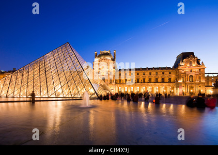 France, Paris, Louvre Museum and Pyramid by the architect Ieoh Ming Pei in the Cour Napoleon, lighting by Claude Engle Stock Photo