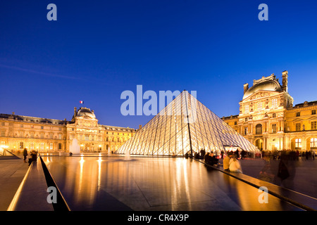 France, Paris, Louvre Museum and Pyramid by the architect Ieoh Ming Pei in the Cour Napoleon, lighting by Claude Engle Stock Photo