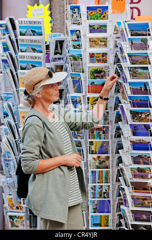 Woman looking at postcards outside a souvenir shop, Sault, Vaucluse, Provence-Alpes-Cote d'Azur, Southern France, France, Europe Stock Photo