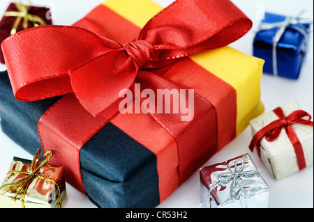 Present wrapped in the German national colours, symbolic image for tax cuts, tax gift Stock Photo