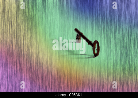 A concept image of an old rim lock key with shadow on a computer generated graduated patterned background Stock Photo
