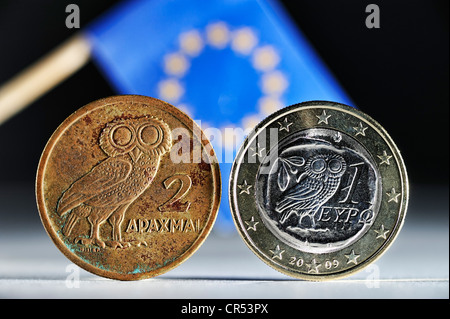 Greek drachma and a Greek one-euro coin in front of the EU flag Stock Photo