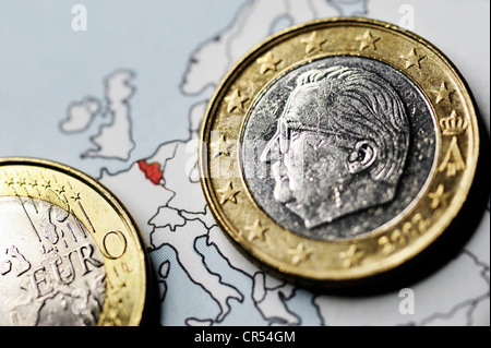 Belgian one-euro coin on a map, symbolic image for the debt crisis in Belgium Stock Photo