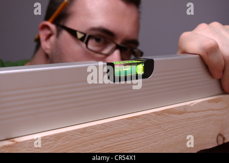 Craftsman using a spirit level Stock Photo