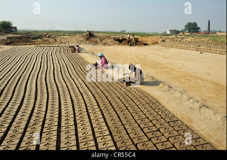 Workers living in bonded labour in a brickyard, most of the workers belong to the Christian minority in Pakistan and are Stock Photo