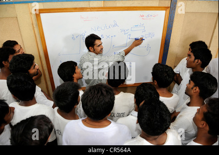 Vocational training as electricians, teacher standing at a whiteboard with vocational students, Youhanabad, Lahore, Punjab Stock Photo