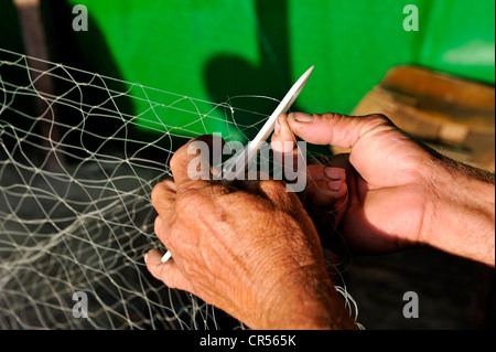 Fisherman mending a net, Pedra de Guaratiba, Sepitiba Bay, Bahia de Sepitiba, Rio de Janeiro, Brazil, South America Stock Photo