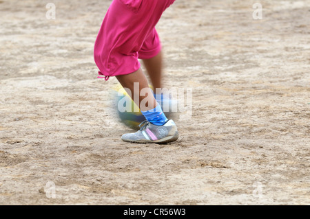 Girl playing soccer, detailed view of the feet with the ball, indigenous community of La Curvita, called Hothaj in the language Stock Photo