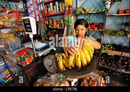 Child labour, girl, 14, working in the shop of her parents, slums of Amauta, Lima, Peru, South America Stock Photo