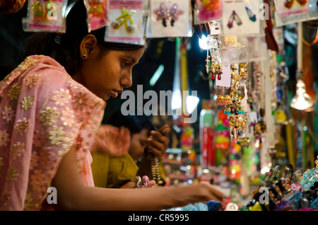 Young woman looking at bangles at street market, Kolkata, West Bengal, India, Asia Stock Photo