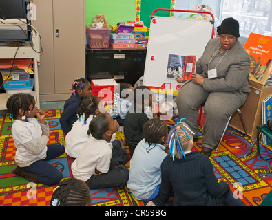 Labor Union Volunteer Reads to First Grade Students Stock Photo