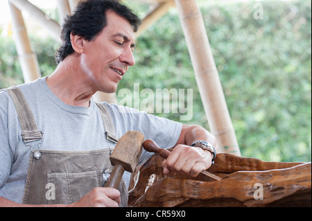 Colombian sculptor working on wood Stock Photo