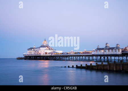 The pier at Eastbourne, Sussex, illuminated at twilight on a perfectly clear summer evening. Stock Photo