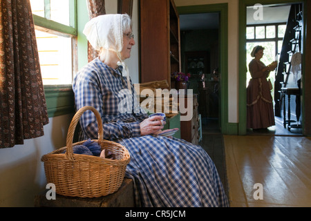 Canada New Brunswick Acadia Fredericton Kings Landing recreated village Maison Perley Perley House women in period outfit in Stock Photo