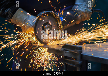 Cutting a steel plate with an angle grinder Stock Photo