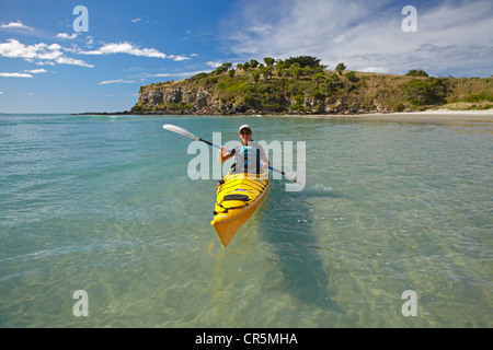 Sea kayak by beach near Doctors Point, and Mapoutahi Pa, Historic Maori Pa Site, north of Dunedin, South Island, New Zealand Stock Photo