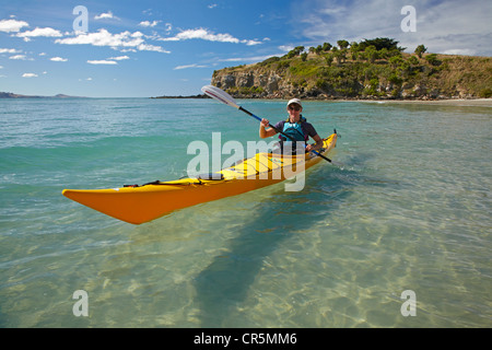 Sea kayak by beach near Doctors Point, and Mapoutahi Pa, Historic Maori Pa Site, north of Dunedin, South Island, New Zealand Stock Photo