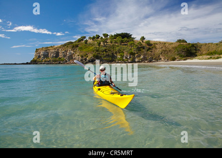 Sea kayak by beach near Doctors Point, and Mapoutahi Pa, Historic Maori Pa Site, north of Dunedin, South Island, New Zealand Stock Photo