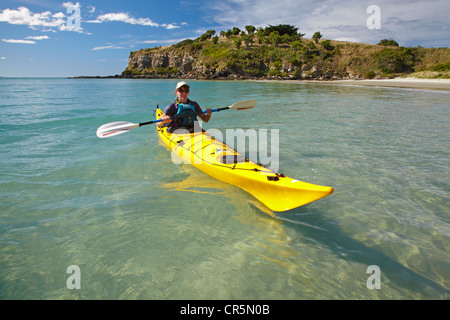 Sea kayak by beach near Doctors Point, and Mapoutahi Pa, Historic Maori Pa Site, north of Dunedin, South Island, New Zealand Stock Photo