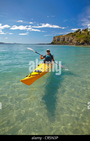 Sea kayak by beach near Doctors Point, and Mapoutahi Pa, Historic Maori Pa Site, north of Dunedin, South Island, New Zealand Stock Photo