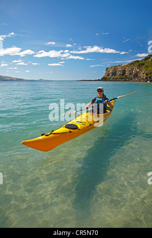 Sea kayak by beach near Doctors Point, and Mapoutahi Pa, Historic Maori Pa Site, north of Dunedin, South Island, New Zealand Stock Photo