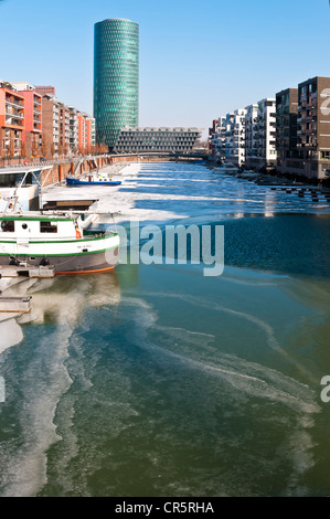 Ice on the Main River in Frankfurt's West Harbour, looking towards Westhafen Tower, nicknamed Apple Wine Tower after the shape Stock Photo