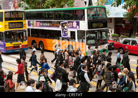 Heavy traffic, pedestrians and vehicles during rush hour in the streets of Hong Kong, China, Asia Stock Photo