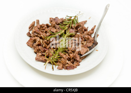 Tibs, Traditioal Ethiopian cusine which is sautéed meat and onions served with rosemerry leaves Stock Photo