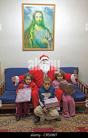 Jordan, Amman, Arabic greek orthodox Church, Santa Claus delivering Christmas gifts to the priest's children Stock Photo