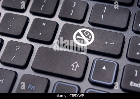 a no smoking sign on keyboard enter key, to convey anti smoking concepts in workplaces or offices. Stock Photo