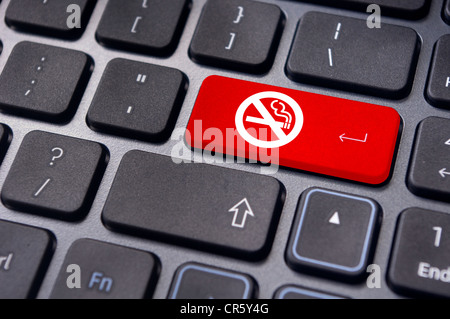 a no smoking sign on keyboard enter key, to convey anti smoking concepts in workplaces or offices. Stock Photo