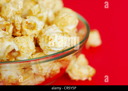 Popcorn in the plate on red background Stock Photo