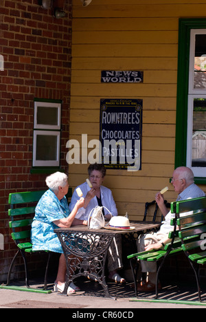 Elderly people enjoying ice creams at cafe on Alresford train station, Watercress Line, Alresford, Hampshire, UK. Stock Photo