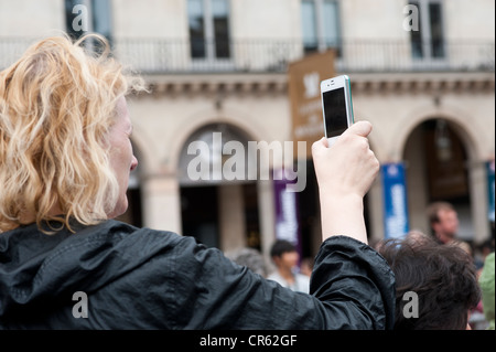 Paris, France - A woman taking photo with mobile phone Iphone Stock Photo