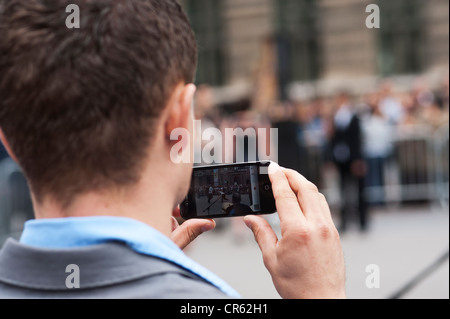 Paris, France - A man taking photo with mobile phone Iphone Stock Photo