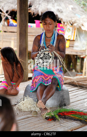 Embera Indian Woman Demonstrating Crafts To Tourists Stock Photo