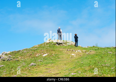 Cornwall, England Uk  - A man and a woman standing on top of a hill looking at the sea Stock Photo