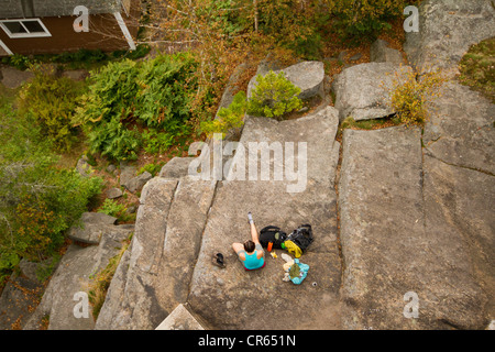 Hikers seen from above taking a break / resting on a rock Stock Photo