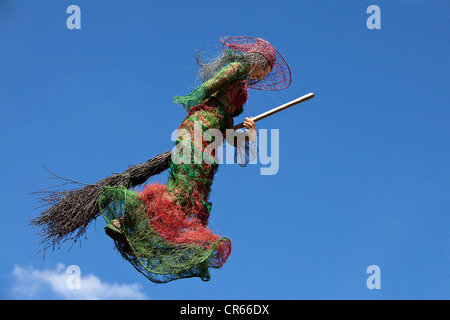 Witch on broom, flying against a blue sky, pedestrian zone, Fulda, Hesse, Germany, Europe Stock Photo