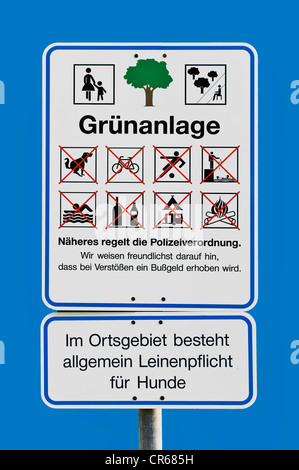 Sign 'Gruenanlage', German for 'park', pictograms showing the do's and don'ts, fines are issued for contempt, 'Im Ortsgebiet Stock Photo
