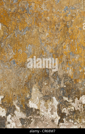 Wall with layers of old paint and plaster, background Stock Photo