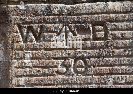war department ordnance survey bench mark marking on a stone wall in broad street in the historic old town of stirling scotland Stock Photo