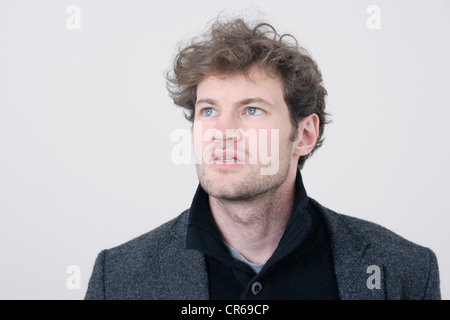 Man with grey coat against white background, close up Stock Photo