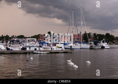 Boats moored at Oulton Broad Lowestoft Suffolk with moody sky July Stock Photo