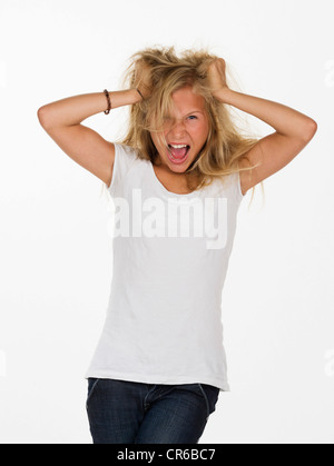 Teenage girl screaming and pulling her hair Stock Photo