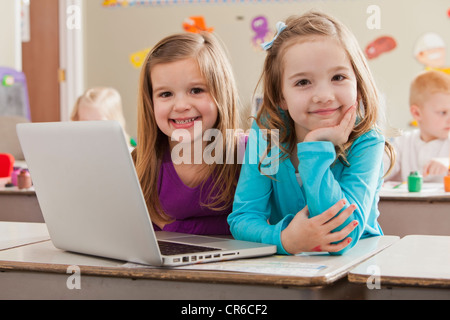 USA, Utah, Orem, Children (4-5, 6-7) at school using laptop Stock Photo