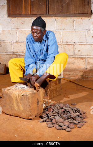 Man producing traditional foot and hand rattles, Juju Rattles from Uyot ...
